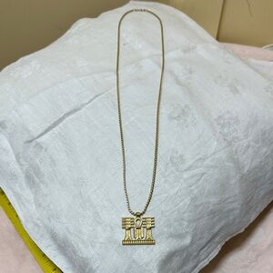 Elegant Gold Tone Necklace with Intricate Pendant